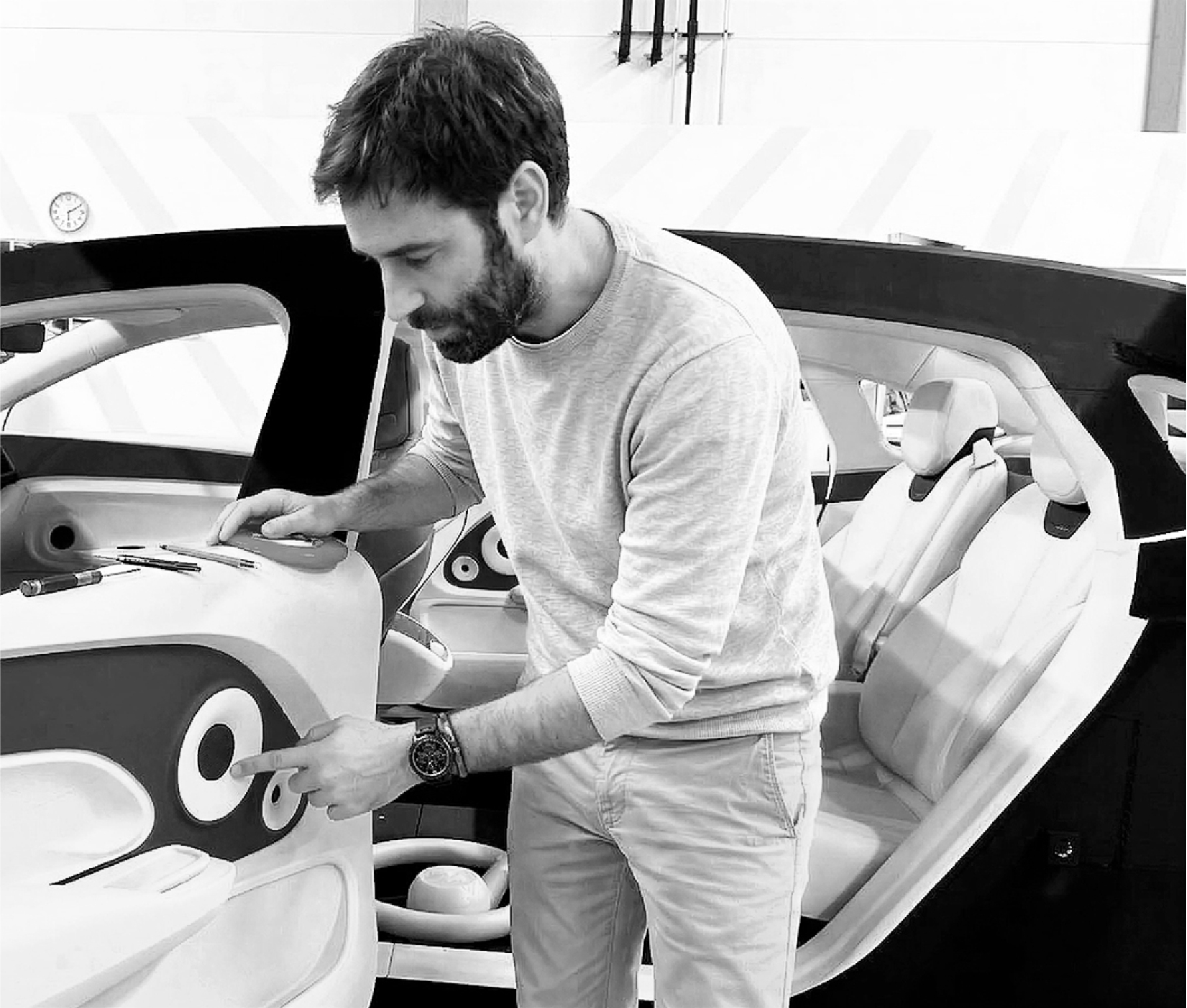 Full-scale interior review — designer evaluating component in clay model